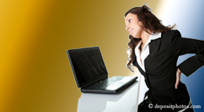 a person McHenry bending over a computer holding her back due to pain