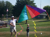 McHenry back pain free grandpa and grandson playing with a kite